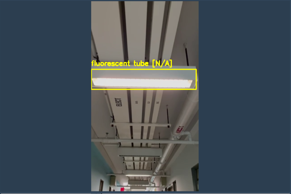 Camera feed showing a fluorescent tube with a yellow bounding box in a corridor ceiling